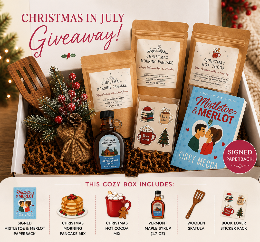 Christmas in July Giveaway box with Mistletoe and Merlot, pancake mix, hot cocoa, maple syrup, a wooden spatula and book lover stickers